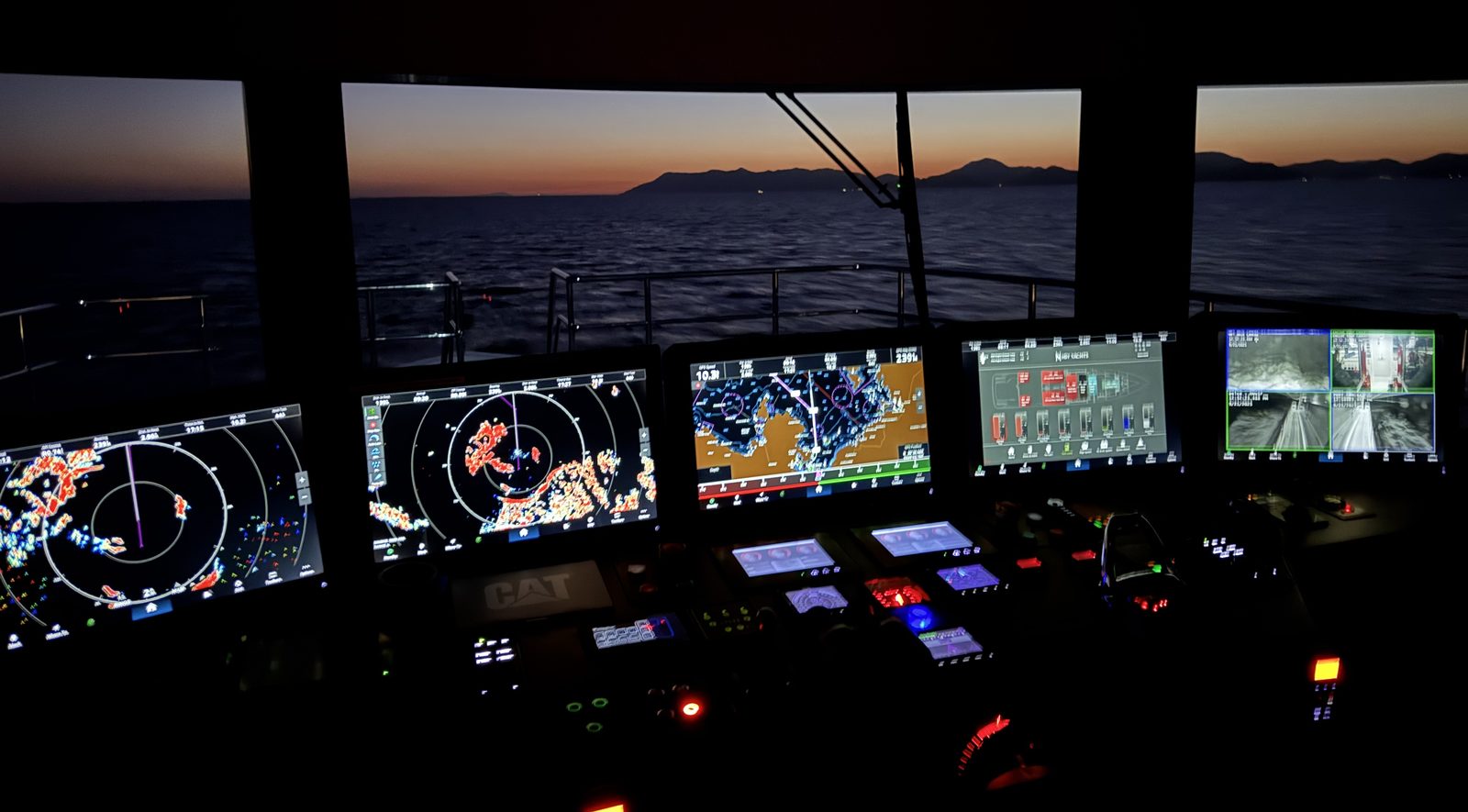 Yacht bridge at sunset with radar and chartplotter screens